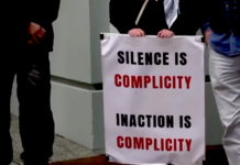 "Silence is complicity" . . . a placard on a sign at the protest outside the Israeli Embassy in Wellington today