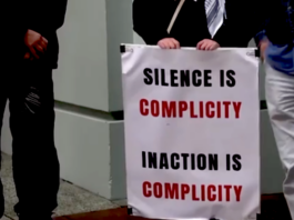 "Silence is complicity" . . . a placard on a sign at the protest outside the Israeli Embassy in Wellington today