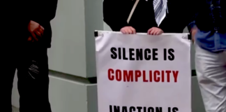 "Silence is complicity" . . . a placard on a sign at the protest outside the Israeli Embassy in Wellington today