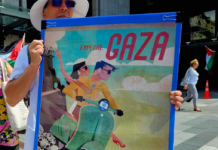 A New Zealand protester holds a poster for the "Trump Gaza" ethnic cleansing plan for a tourism development