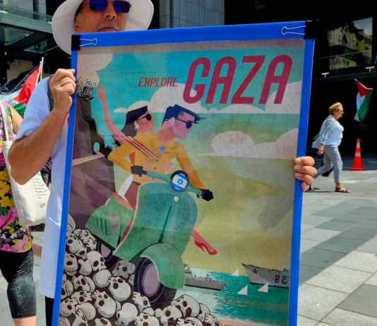 A New Zealand protester holds a poster for the "Trump Gaza" ethnic cleansing plan for a tourism development