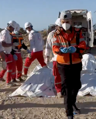 Red Crescent rescue workers recover bodies of the 15 Palestinian ambulance and first responder crews killed by Israeli forces