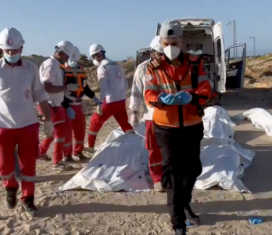 Red Crescent rescue workers recover bodies of the 15 Palestinian ambulance and first responder crews killed by Israeli forces