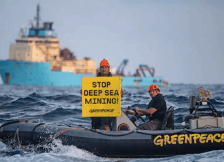 Greenpeace International activists display a banner in front of the Maersk Launcher