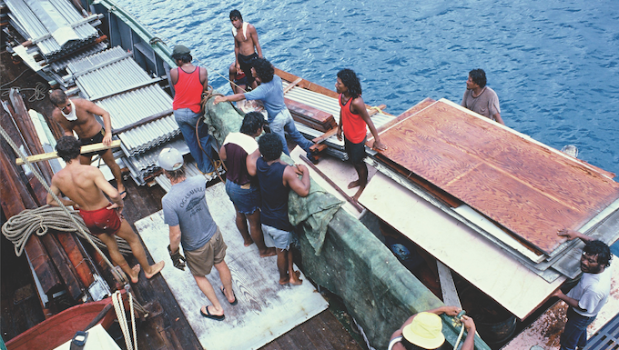 Loading demolished house materials from Rongelap on board the Rainbow Warrior
