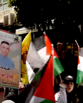 Palestinians march in protest today over the thousands of prisoners being held in Israeli jails