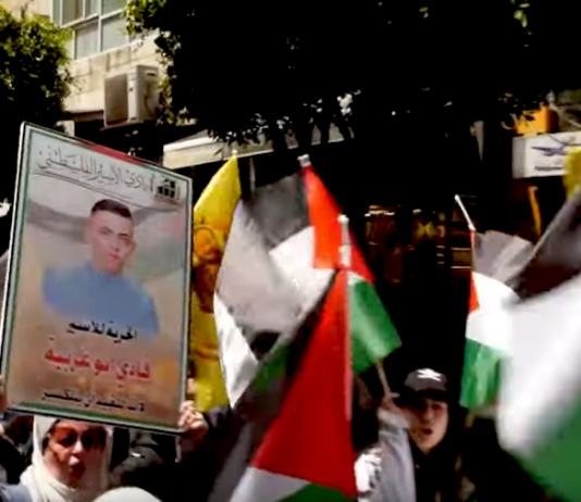 Palestinians march in protest today over the thousands of prisoners being held in Israeli jails