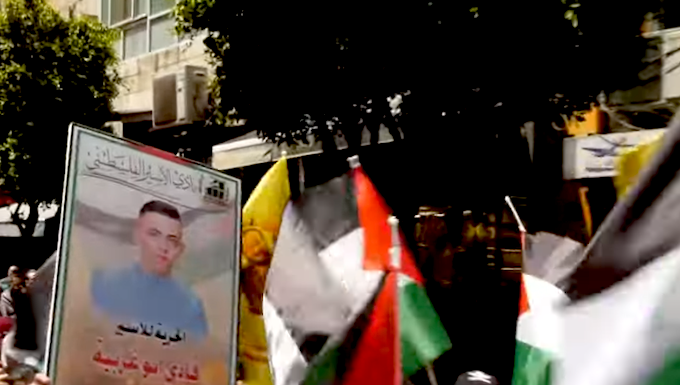 Palestinians march in protest today over the thousands of prisoners being held in Israeli jails