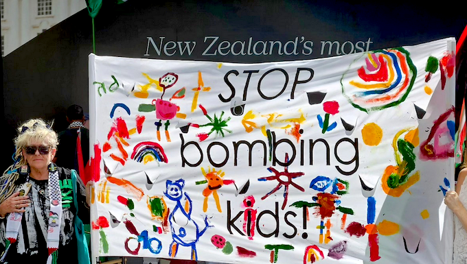 "Stop bombing kids" . . . a banner at the solidarity rally in Auckland's "Palestine Corner"