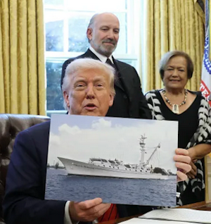 President Donald Trump signs a proclamation in the Oval Office at the White House last month