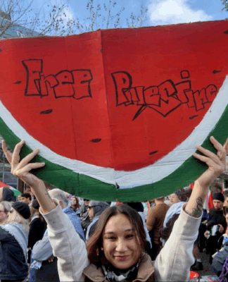 Protesters with a "Free Palestine" watermelon placard at the ceasefire rally in the West Auckland suburb of Henderson