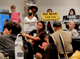 CNMI and Guam activists stage a rally protesting against the US military buildup in the Marianas