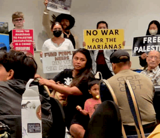 CNMI and Guam activists stage a rally protesting against the US military buildup in the Marianas