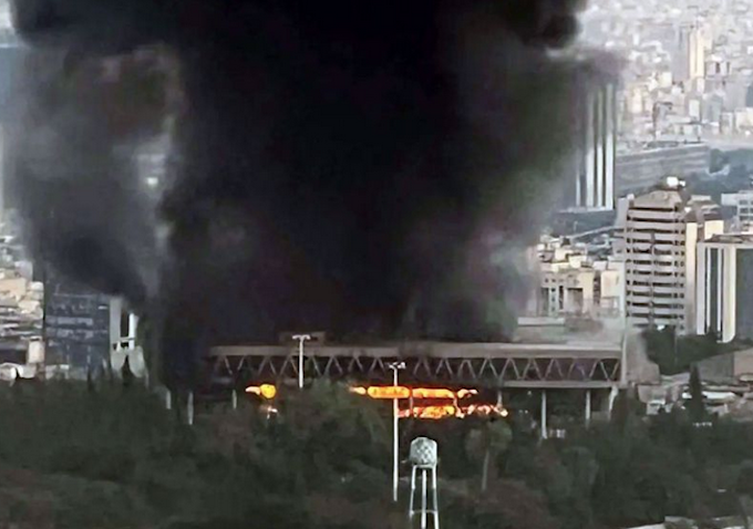 Plumes of black smoke billowing after an Israeli attack against Iran's state broadcaster