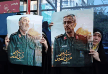 Iranians hold posters of late Islamic Revolutionary Guard Corps head Hossein Salami (left), and late Iranian Armed Forces Chief of Staff General Mohammad Bagheri (right), who were killed in Israeli airstrikes in recent days