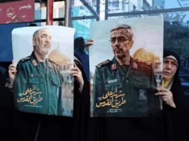 Iranians hold posters of late Islamic Revolutionary Guard Corps head Hossein Salami (left), and late Iranian Armed Forces Chief of Staff General Mohammad Bagheri (right), who were killed in Israeli airstrikes in recent days