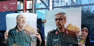 Iranians hold posters of late Islamic Revolutionary Guard Corps head Hossein Salami (left), and late Iranian Armed Forces Chief of Staff General Mohammad Bagheri (right), who were killed in Israeli airstrikes in recent days
