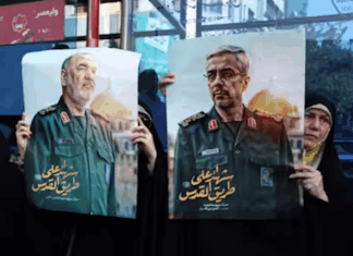 Iranians hold posters of late Islamic Revolutionary Guard Corps head Hossein Salami (left), and late Iranian Armed Forces Chief of Staff General Mohammad Bagheri (right), who were killed in Israeli airstrikes in recent days