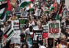 Protesters shout slogans and hold placards during a national demonstration against the Israeli wars on Gaza, occupied Palestine and Iran