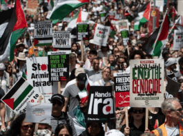 Protesters shout slogans and hold placards during a national demonstration against the Israeli wars on Gaza, occupied Palestine and Iran