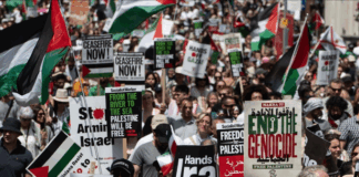 Protesters shout slogans and hold placards during a national demonstration against the Israeli wars on Gaza, occupied Palestine and Iran
