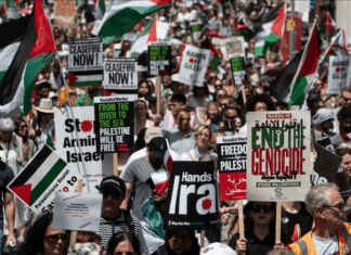 Protesters shout slogans and hold placards during a national demonstration against the Israeli wars on Gaza, occupied Palestine and Iran