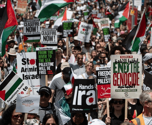 Protesters shout slogans and hold placards during a national demonstration against the Israeli wars on Gaza, occupied Palestine and Iran