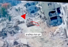A Merkava tank in Gaza pictured at the moment a Hamas resistance fighter emerged from a tunnel to plant an explosive device