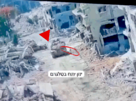 A Merkava tank in Gaza pictured at the moment a Hamas resistance fighter emerged from a tunnel to plant an explosive device