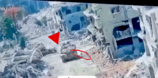 A Merkava tank in Gaza pictured at the moment a Hamas resistance fighter emerged from a tunnel to plant an explosive device