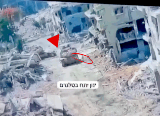 A Merkava tank in Gaza pictured at the moment a Hamas resistance fighter emerged from a tunnel to plant an explosive device