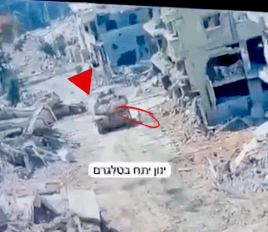 A Merkava tank in Gaza pictured at the moment a Hamas resistance fighter emerged from a tunnel to plant an explosive device