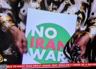 A "No Iran War" placard as protests across Iran and around the world condemn Israeli and US aggression