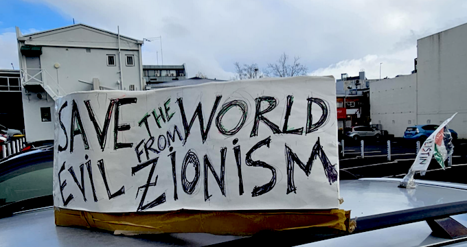 A "Save the world from evil Zionism" placard
