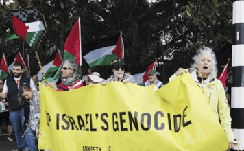 Public protest in the NZ naval base suburb of Auckland . . . local resident Margaret Taylor of Amnesty International (right) at the front of the Devonport Out For Gaza march on Victoria Rd