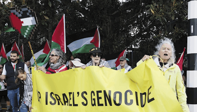 Flying the flags for Palestine – NZ protesters take message to Devonport Public protest in the NZ naval base suburb of Auckland . . . local resident Margaret Taylor of Amnesty International (right) at the front of the Devonport Out For Gaza march on Victoria Rd