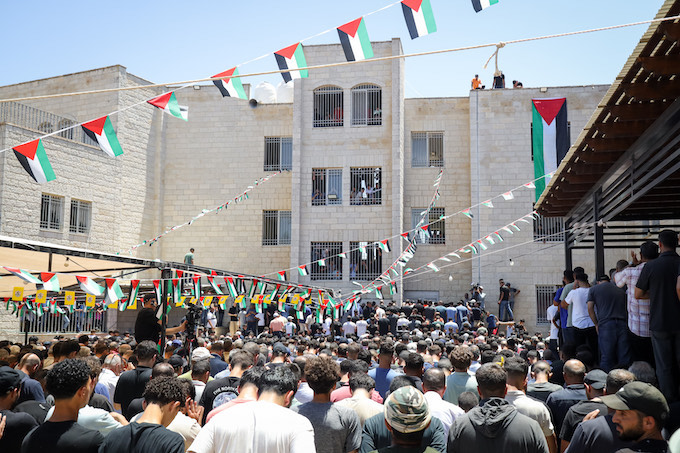Mourners pay their respects to the two young Palestinians killed by illegal settlers