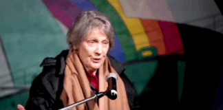 Former NZ prime minister Helen Clark speaking on the deck of the Rainbow Warrior