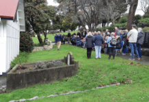 Porirua Cemetery manager Daniel Chrisp speaks at the Family Forum beside the chapel, as Mayor Anita Baker and whānau gather to honour 1800 patients buried in unmarked graves