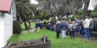 Porirua Cemetery manager Daniel Chrisp speaks at the Family Forum beside the chapel, as Mayor Anita Baker and whānau gather to honour 1800 patients buried in unmarked graves