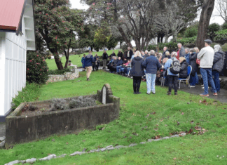 Porirua Cemetery manager Daniel Chrisp speaks at the Family Forum beside the chapel, as Mayor Anita Baker and whānau gather to honour 1800 patients buried in unmarked graves