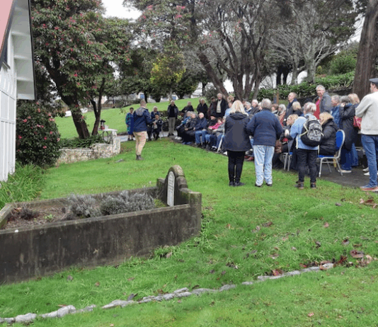 Porirua Cemetery manager Daniel Chrisp speaks at the Family Forum beside the chapel, as Mayor Anita Baker and whānau gather to honour 1800 patients buried in unmarked graves