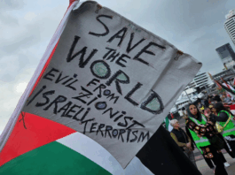 A "save the world" banner at last Saturday's pro-Palestinian march in Auckland's Viaduct precinct