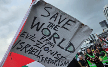 A "save the world" banner at last Saturday's pro-Palestinian march in Auckland's Viaduct precinct