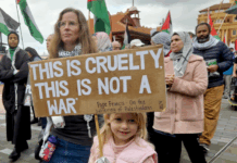 "This is cruelty - this is not a war," says this young girl's placard quoting the Pope