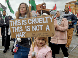 "This is cruelty - this is not a war," says this young girl's placard quoting the Pope