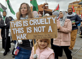 "This is cruelty - this is not a war," says this young girl's placard quoting the Pope