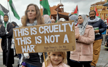 "This is cruelty - this is not a war," says this young girl's placard quoting the Pope