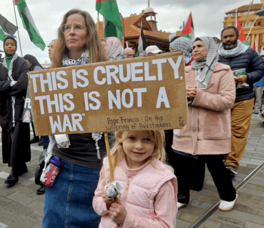 "This is cruelty - this is not a war," says this young girl's placard quoting the Pope