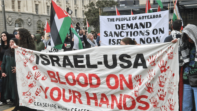 Leaked document reveals proposed law revisions in NZ, as Western defence of Zionist genocide threatens Pacific An "Israel-USA - blood on your hands" banner at a pro-Palestinian rally in Auckland last Saturday